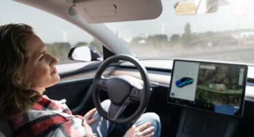 Woman Distracted While Car on Autopilot.