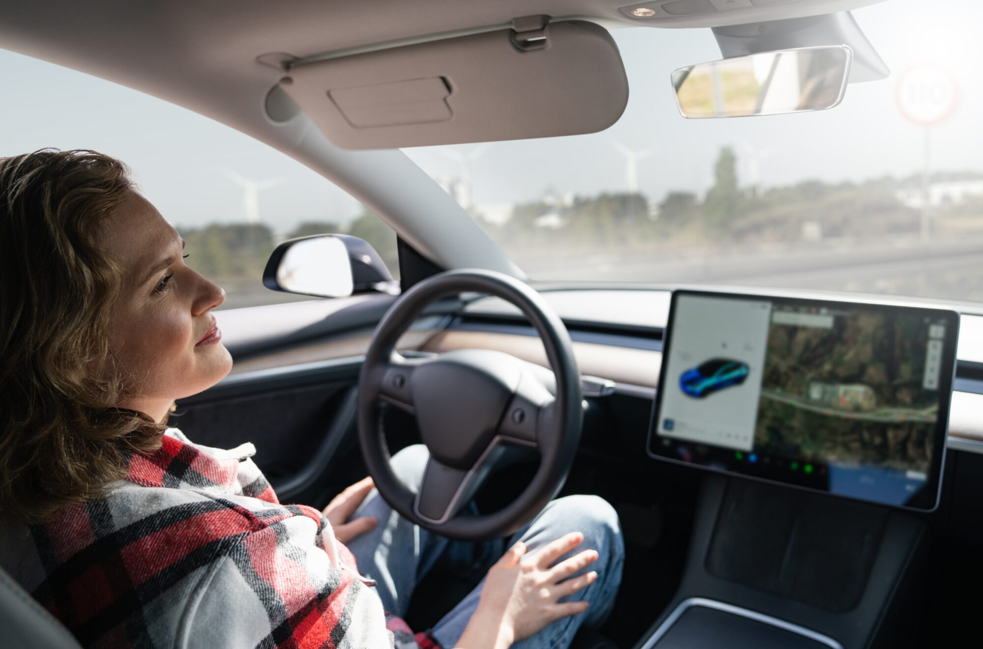 Woman Distracted While Car on Autopilot.